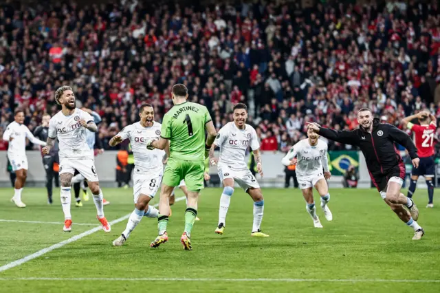 Emiliano Martinez celebrates his success in Aston Villa's penalty shootout win over Lille