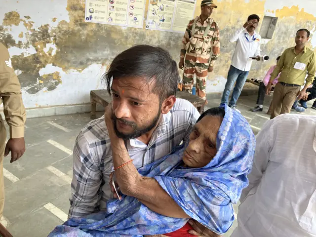 Ms Rameshwari being carried to the polling booth by her grandson