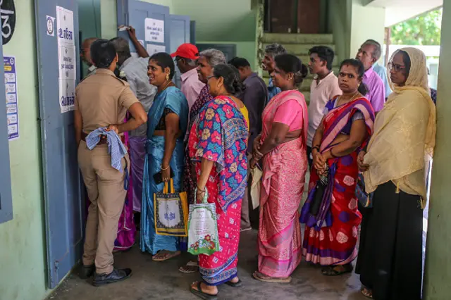 Voters queue at a polling station during the first phase of voting for national elections in Chennai, Tamil Nadu