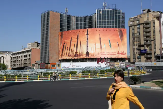 People walk on the streets of Iran's capital Tehran on April 19