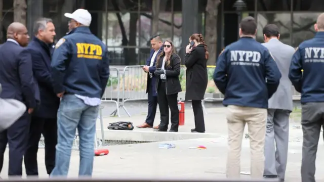 Investigators outside the scene where an unknown man set himself on fire.