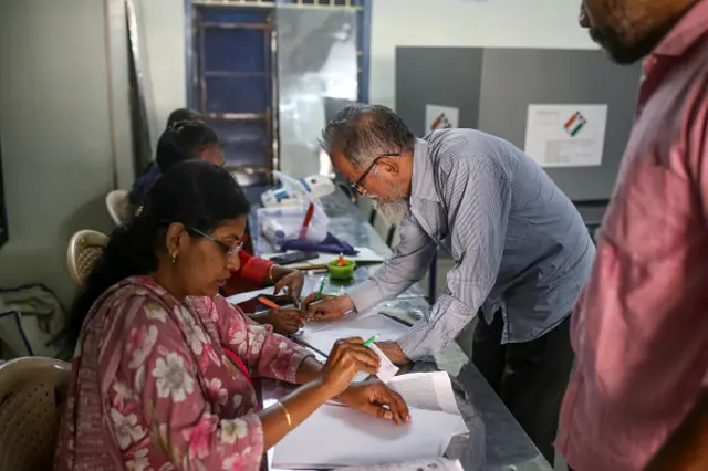 Voters register at a polling station during the first phase of voting for national elections in Chennai, Tamil Nadu, India