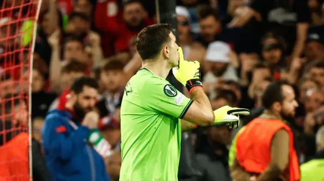 Emiliano Martinez gestures to the Lille fans