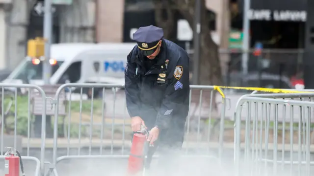 Police officer in new york with fire extinguisher