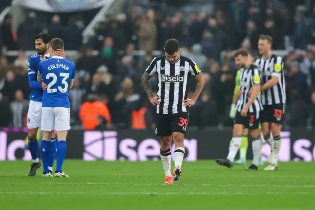 Guimaraes looks at the turf as he trudges back to kick off after Everton's goal