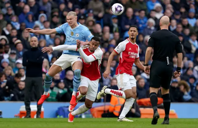 Manchester City's Erling Haaland is challenged by Arsenal's Gabriel