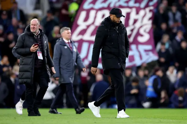 Kompany walks across the pitch before kick off