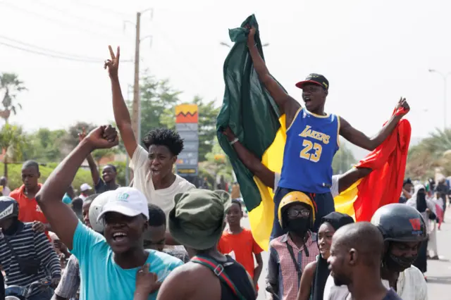 A supporter of Malian Interim President holds up the flag of Mali during a pro-Junta and pro-Russia rally in Bamako on May 13, 2022.