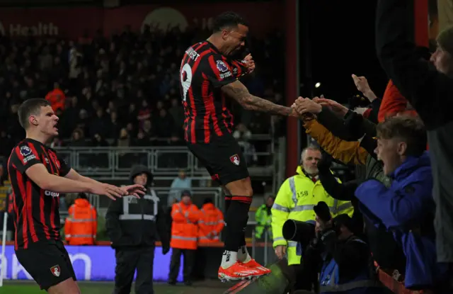 Kluivert stands on the advertising board and celebrates with fans