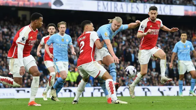 Arsenal's William Saliba blocks a shot by Manchester City's Erling Haaland