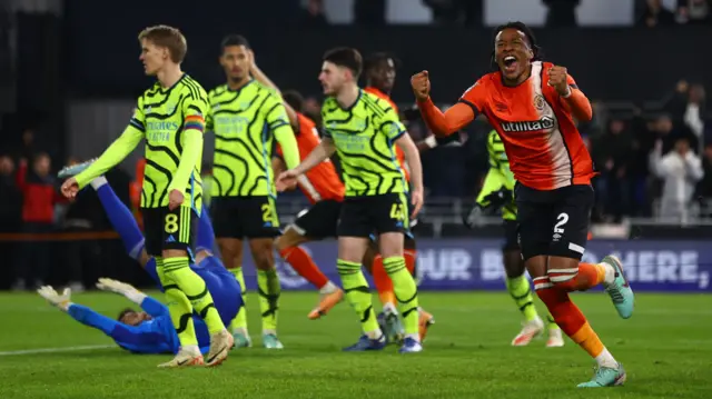 Gabriel Osho celebrates after team-mate Elijah Adebayo scores for Luton against Arsenal