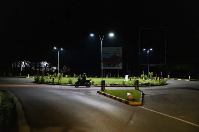 Street lighting on a roundabout at night in Arusha, Tanzania - February 2022