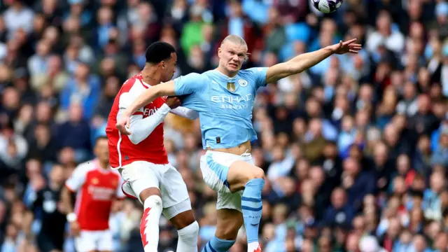 Arsenal's Gabriel pulls the shirt of Manchester City's Erling Haaland