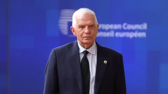 Josep Borrell  walking inside a European Council building