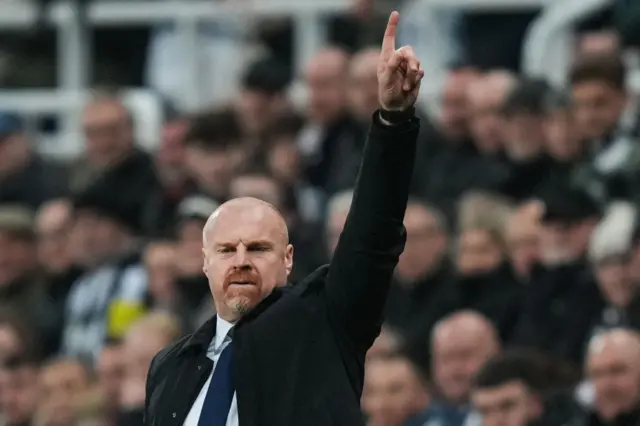 Dyche points to the sky to gesture instructions to his players