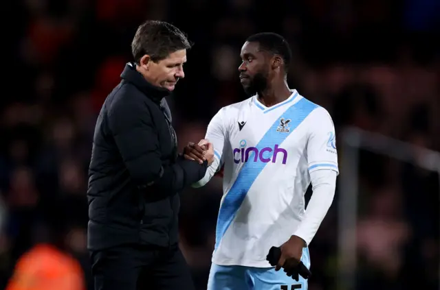 Glasner and Schlupp shake hands on the pitch at full time