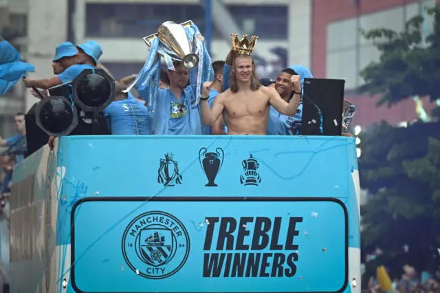 Erling Haaland celebrates on top of a bus during Manchester City's 2023 trophy parade