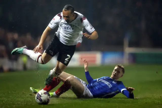 Derby County's Kane Wilson (left) is challenged by Portsmouth's Paddy Lane