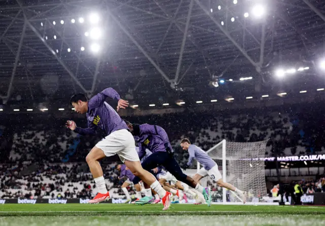 Spurs players warm up at London stadium