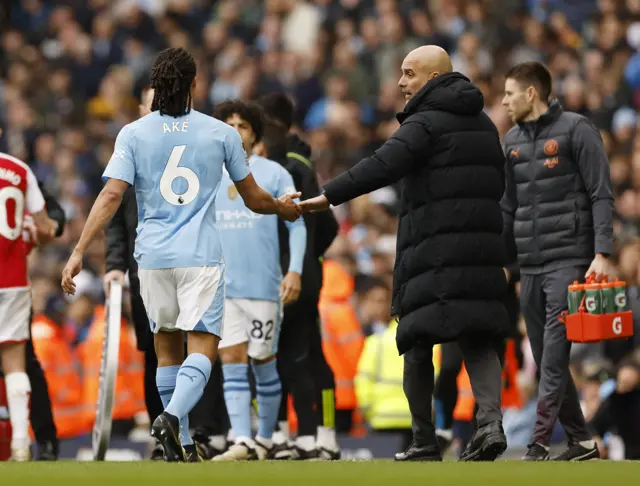 An injured Nathan Ake is brought off by Manchester City boss Pep Guardiola