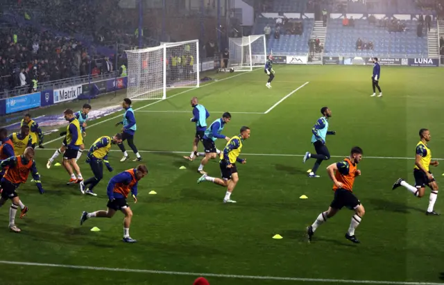 Players warm up before Portsmouth v Derby