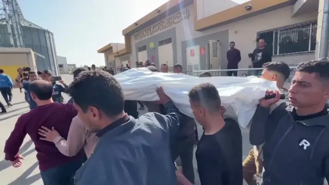 Friends carry the body of Saif Abu Taha