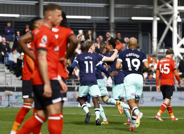 Luton commiserate while Luton celebrate one of their goals