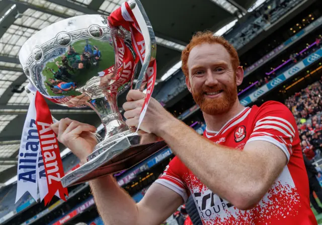 Derry skipper Conor Glass holds the trophy aloft as Derry won the Division One title for the first time since 2008