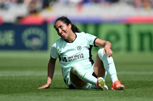 Ramirez smiles as she sits on the turf