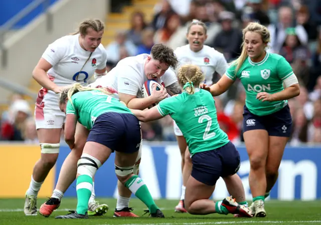 Hannah Botterman of England is tackled by Edel McMahon and Neve Jones