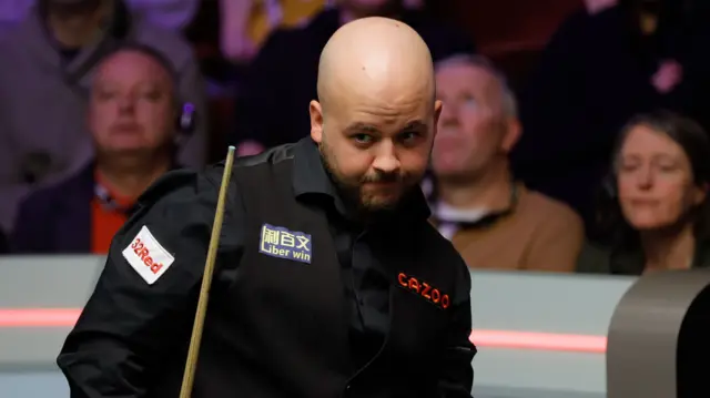 Luca Brecel looks at the table