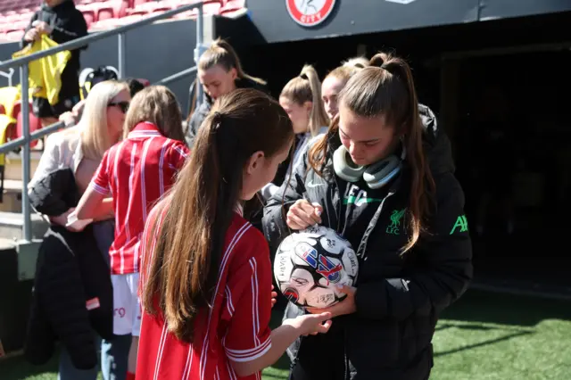 Lucy Parry signs a match ball