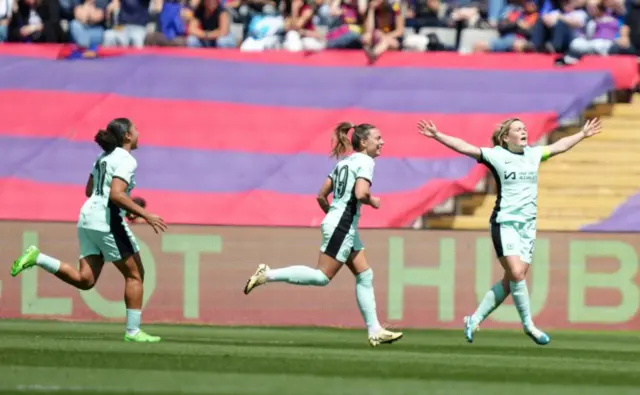 Cuthbert celebrates her goal v Barcelona by holding her arms in the air