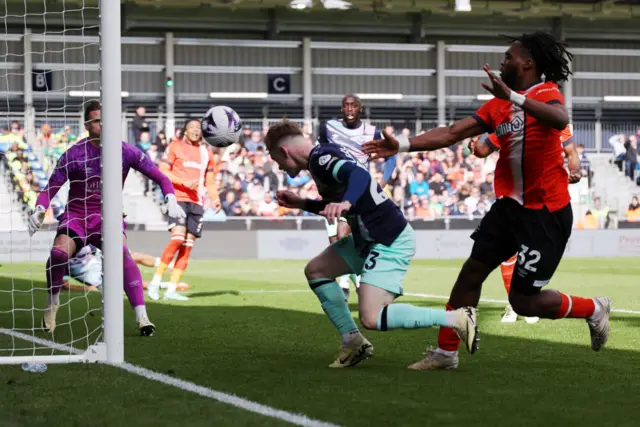 Keane Lewis-Potter heads the ball in at the back post for Brentford's fourth.