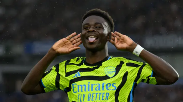 Bukayo Saka celebrates scoring at Brighton