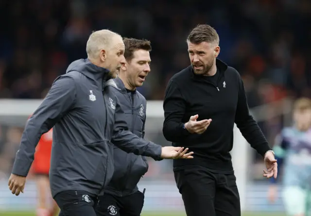 Rob Edwards speaks to his coaching staff