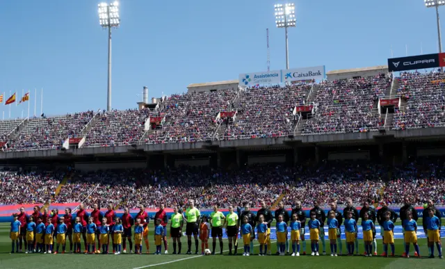 The teams line up before kick off