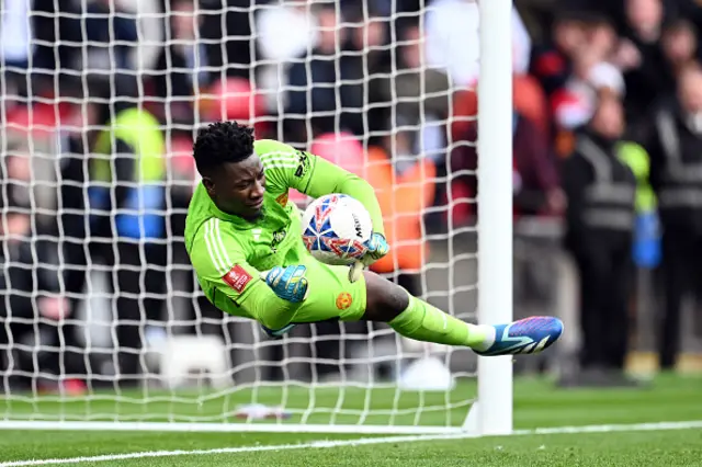 Andre Onana of Manchester United saves the third penalty