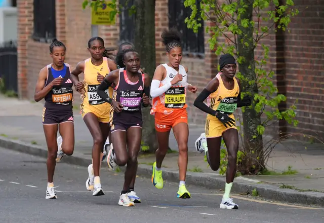 Competitors including Tigist Ketema, Tigst Assefa, Joyciline Jepkosgei, Yalemzerf Yehualaw, Peres Jepchirchir in action just past the mile 16 stage in the women's elite race during the TCS London Marathon.