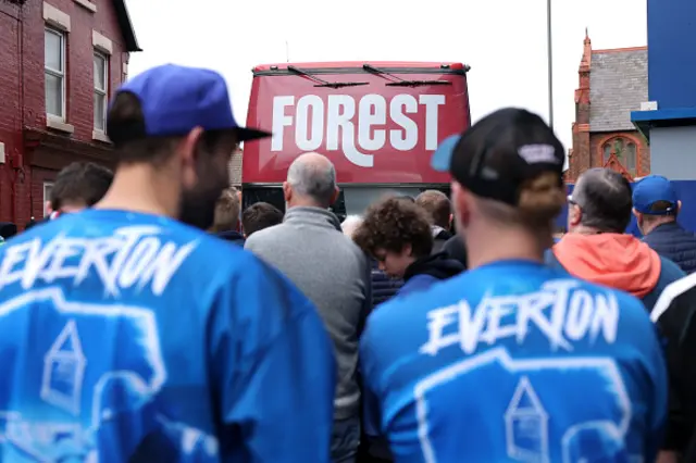 Everton fans can be seen wearing team merchandise on their way to the stadium