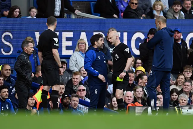 Rui Pedro Silva, Assistant Manager of Nottingham Forest, speaks with Referee Anthony Taylor