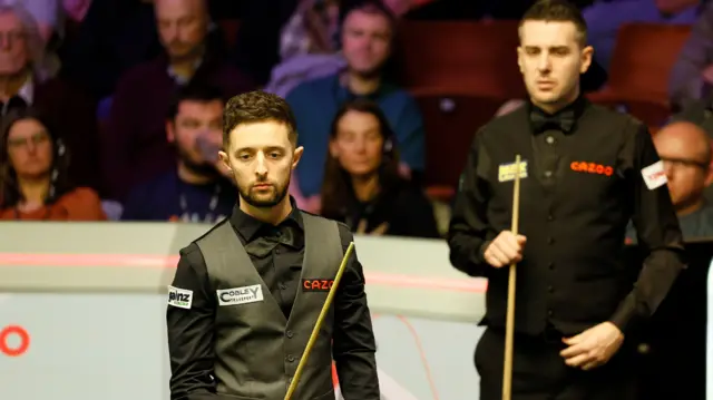 Joe O’Connor and Mark Selby look at the table