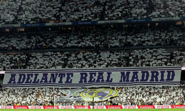 Real Madrid fans unfold a banner reading "Go Real Madrid"