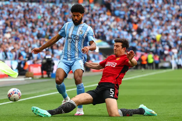 Harry Maguire of Manchester United tackles Ellis Simms