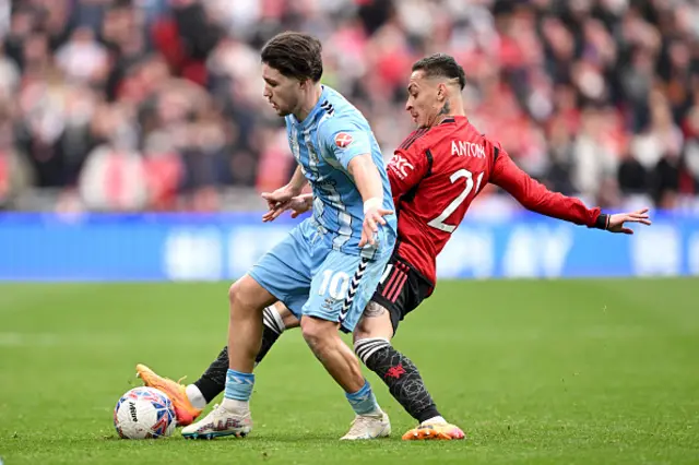 Callum O'Hare of Coventry City is challenged by Antony