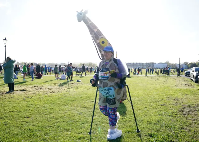 A runner in a giraffe outfit at the London Marathon