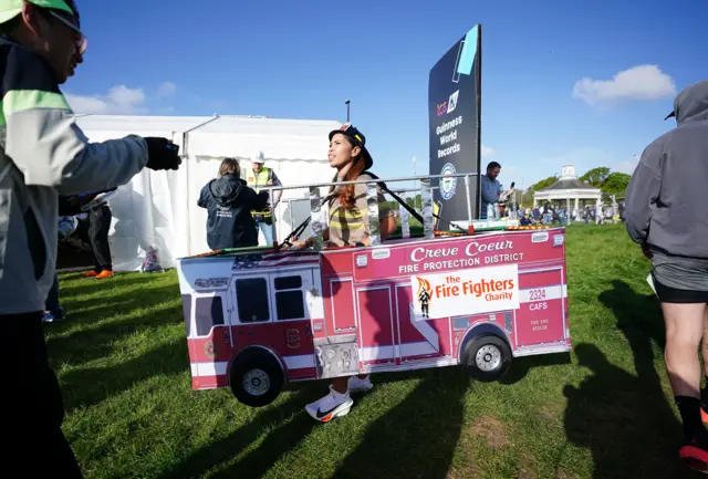 A runner in a fire engine costume at the London Marathon