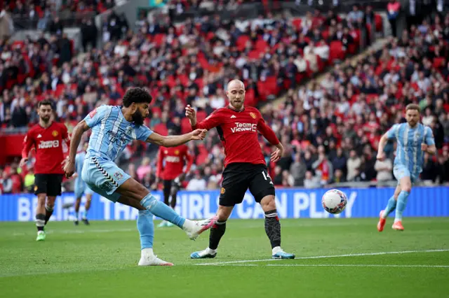 Ellis Simms of Coventry City shoots past Christian Eriksen