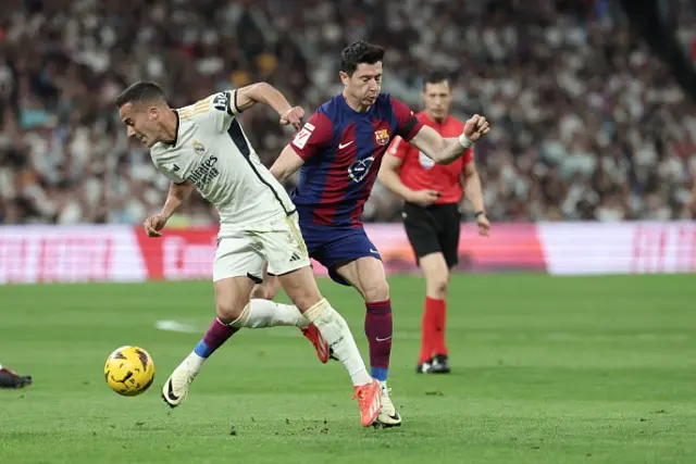 Lucas Vazquez fights for the ball with Barcelona's Polish forward Robert Lewandowski