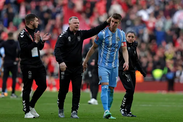 Mark Robins (C) consoles Coventry City's English midfielder #14 Ben Sheaf